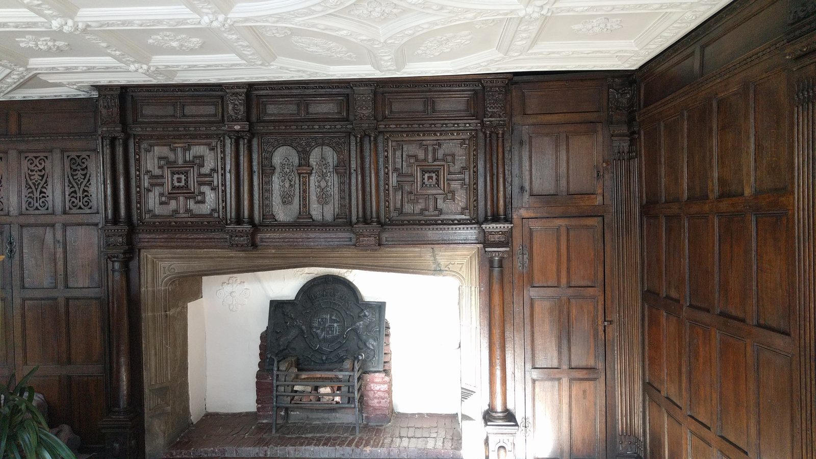 Seventeenth-century oak panelling around the fireplace in the principal first floor room, after treatment
