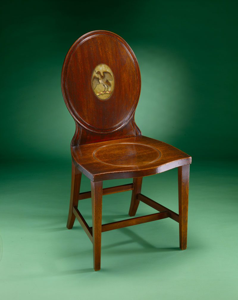 Mahogany hall chair with the Hall Clarke family crest painted on the oval back panel