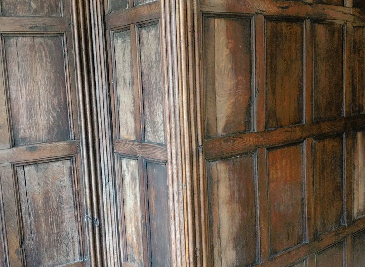 Detail of seventeenth-century oak panelling before conservation